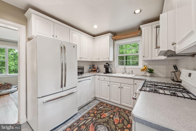 4260 25th St N, Arlington, VA 22207 - kitchen with a sink, white cabinetry, white appliances, decorative backsplash, and recessed lighting