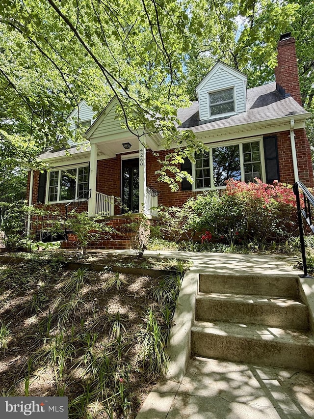 4260 25th St N, Arlington, VA 22207 - view of front of property with a chimney, brick siding, and covered porch