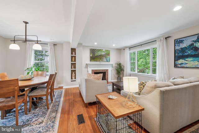 4260 25th St N, Arlington, VA 22207 - living room with baseboards, a healthy amount of sunlight, visible vents, and wood finished floors