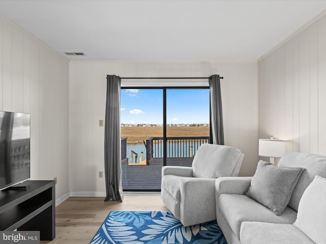 674 94th St Unit 154, Ocean City, MD 21842 - living room featuring crown molding, a water view, light wood-type flooring, baseboards, and visible vents