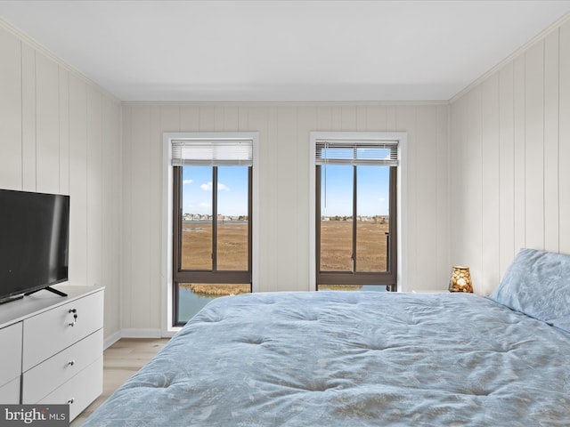 674 94th St Unit 154, Ocean City, MD 21842 - bedroom featuring ornamental molding, light wood finished floors, baseboards, and multiple windows