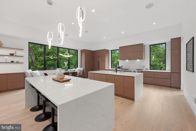 6018 Woodland Ter, Mclean, VA 22101 - kitchen with modern cabinets, a large island, plenty of natural light, brown cabinets, and recessed lighting