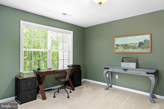 office area with baseboards, visible vents, and light carpet