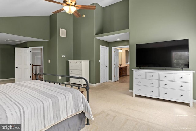 bedroom with visible vents, baseboards, high vaulted ceiling, and light colored carpet