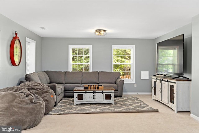 living area with baseboards, carpet flooring, and visible vents