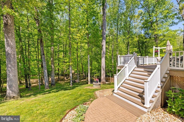 view of yard featuring stairway and a deck
