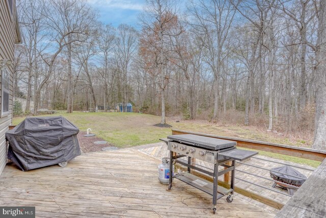 519 Squawigm Rd, Dover, DE 19901 - wooden terrace featuring a yard and a grill