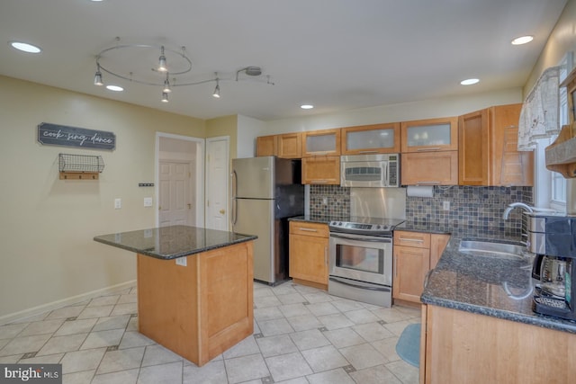 519 Squawigm Rd, Dover, DE 19901 - kitchen with a center island, dark stone countertops, a sink, backsplash, and appliances with stainless steel finishes