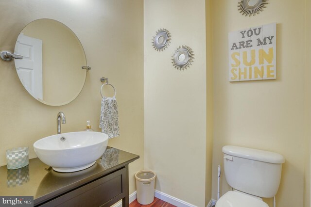 519 Squawigm Rd, Dover, DE 19901 - half bathroom with toilet, vanity, and baseboards