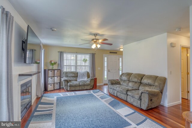 519 Squawigm Rd, Dover, DE 19901 - living area with visible vents, wood finished floors, a glass covered fireplace, and ceiling fan