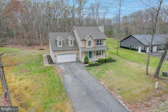 519 Squawigm Rd, Dover, DE 19901 - traditional-style home featuring a porch, a chimney, a shingled roof, a front yard, and aphalt driveway