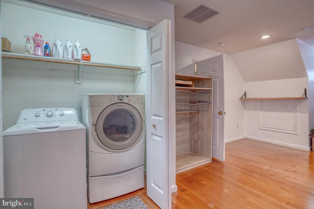 519 Squawigm Rd, Dover, DE 19901 - laundry area with laundry area, visible vents, washing machine and dryer, light wood-type flooring, and baseboards