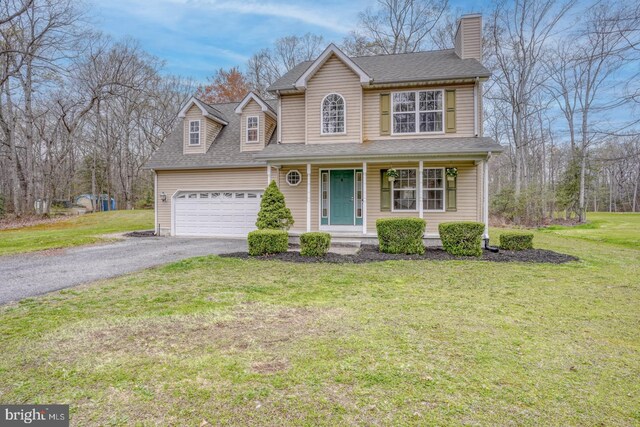 519 Squawigm Rd, Dover, DE 19901 - traditional home featuring a chimney, aphalt driveway, covered porch, an attached garage, and roof with shingles