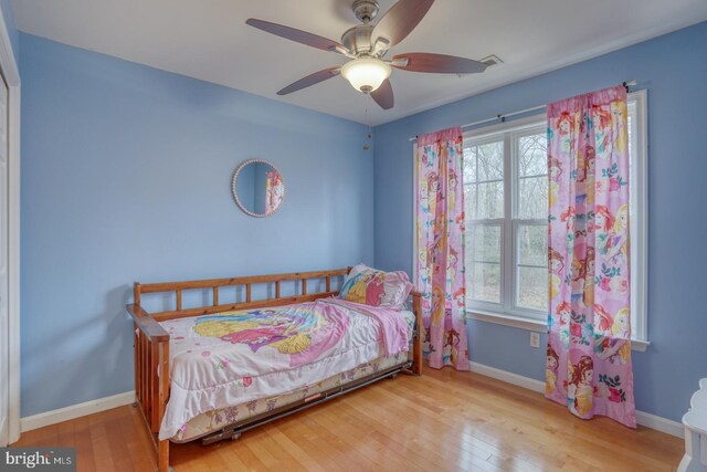 519 Squawigm Rd, Dover, DE 19901 - bedroom featuring wood-type flooring, baseboards, multiple windows, and ceiling fan