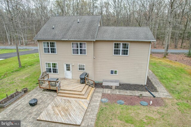 519 Squawigm Rd, Dover, DE 19901 - rear view of property with a wooden deck, a yard, a forest view, and roof with shingles
