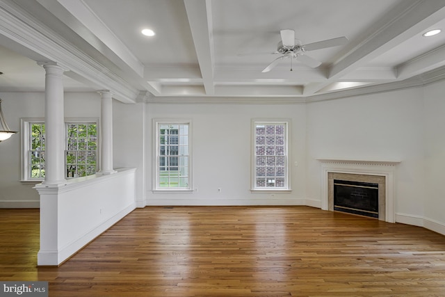 unfurnished living room with a ceiling fan, beam ceiling, wood finished floors, and a fireplace