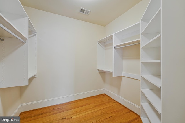 spacious closet featuring visible vents and light wood finished floors