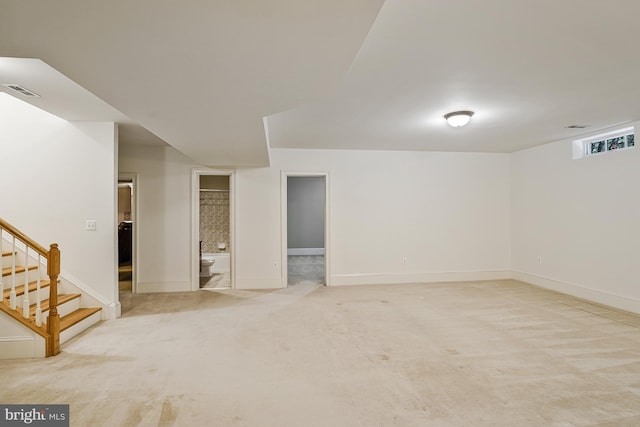 below grade area with stairs, baseboards, visible vents, and carpet floors