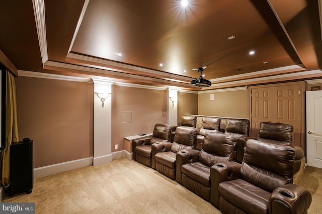 carpeted cinema with baseboards, ornamental molding, and a tray ceiling