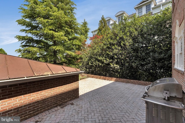 view of patio / terrace featuring area for grilling and fence
