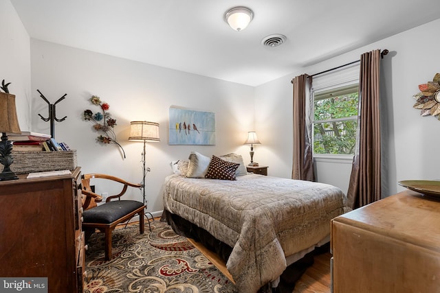 bedroom with wood finished floors and visible vents
