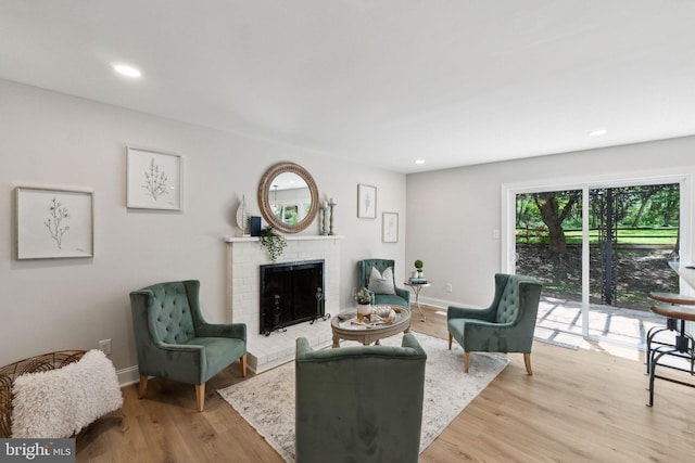 living room with a fireplace, light wood-type flooring, recessed lighting, and baseboards