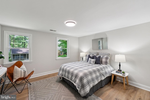 bedroom featuring baseboards and wood finished floors