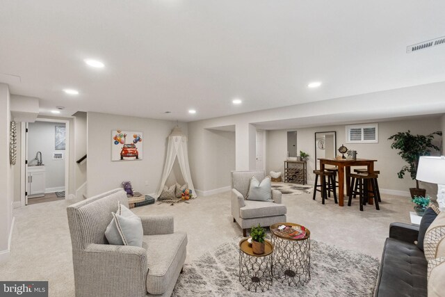 living area with recessed lighting, carpet flooring, baseboards, and stairs