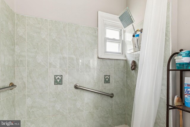 bathroom with tiled shower