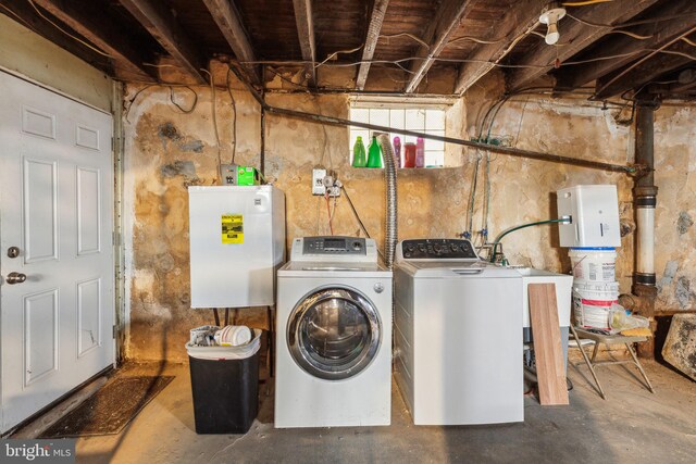 clothes washing area with separate washer and dryer and laundry area