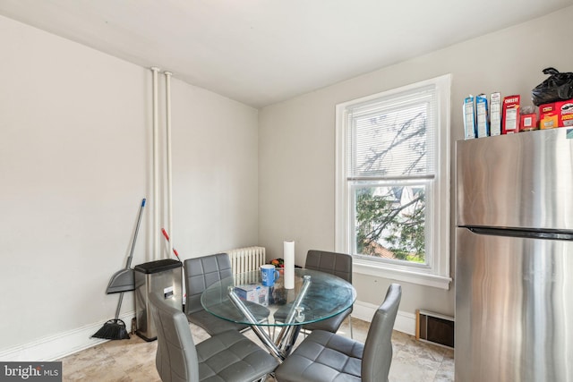 dining room featuring baseboards, radiator heating unit, and visible vents