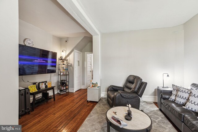 living room featuring baseboards and hardwood / wood-style flooring