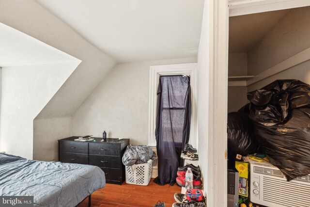 bedroom featuring vaulted ceiling and wood finished floors