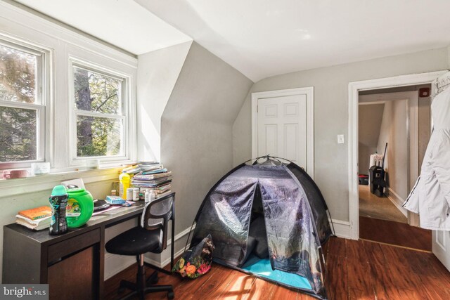 bedroom featuring vaulted ceiling, wood finished floors, and baseboards