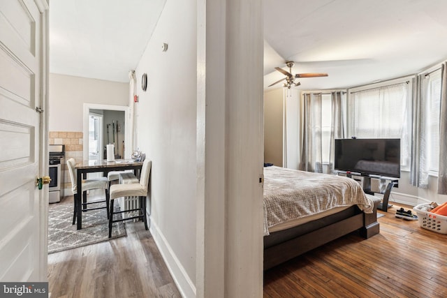 bedroom with wood finished floors and baseboards