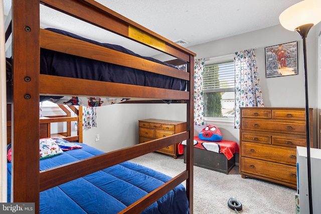 carpeted bedroom featuring visible vents
