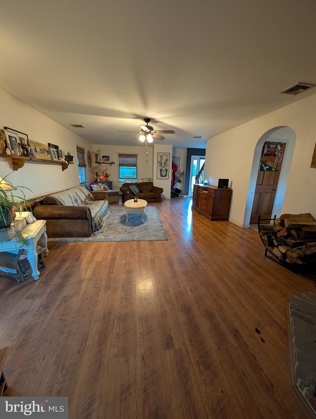 61 Perry Rd, Woodbine, NJ 08270 - living area with arched walkways, wood finished floors, visible vents, and ceiling fan