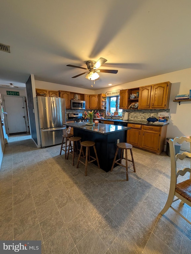 61 Perry Rd, Woodbine, NJ 08270 - kitchen featuring open shelves, tasteful backsplash, a breakfast bar area, and stainless steel appliances