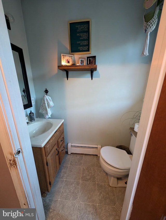 61 Perry Rd, Woodbine, NJ 08270 - bathroom with tile patterned floors, vanity, a baseboard radiator, and toilet