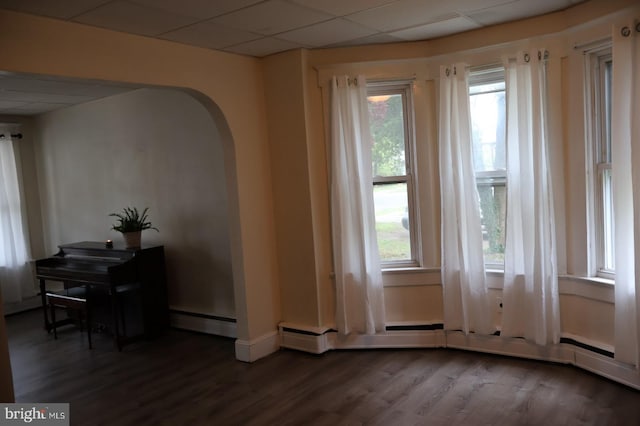 416 Lynwood Ave, Hamilton, NJ 08629 - unfurnished room with a baseboard heating unit, a wealth of natural light, arched walkways, and wood finished floors