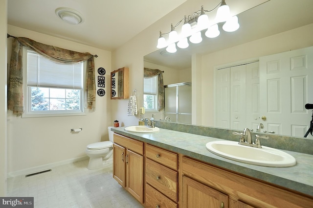 bathroom with plenty of natural light, visible vents, a stall shower, and a sink