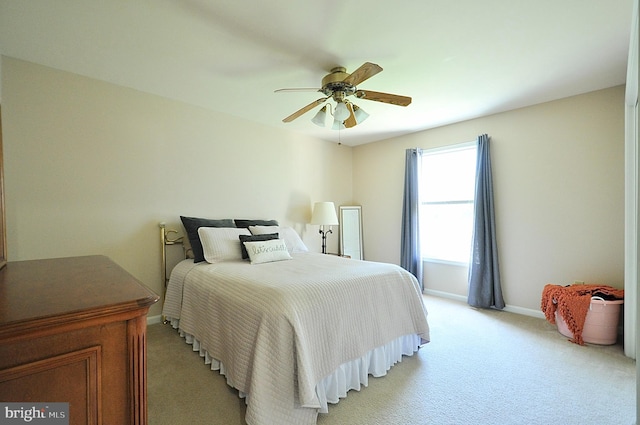 bedroom featuring light carpet, baseboards, and ceiling fan