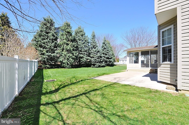 view of yard featuring a sunroom, a patio, and fence