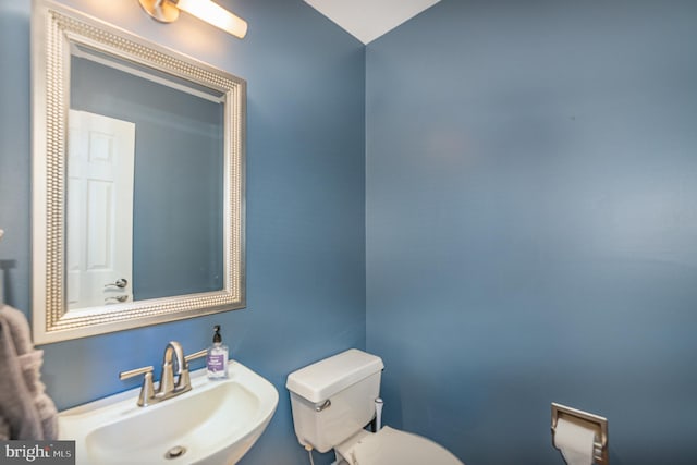 half bathroom with a sink and toilet