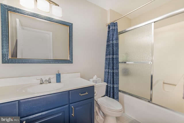 bathroom featuring toilet, enclosed tub / shower combo, and vanity