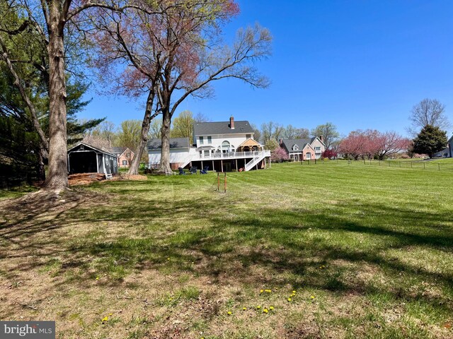 view of yard featuring a wooden deck and stairway