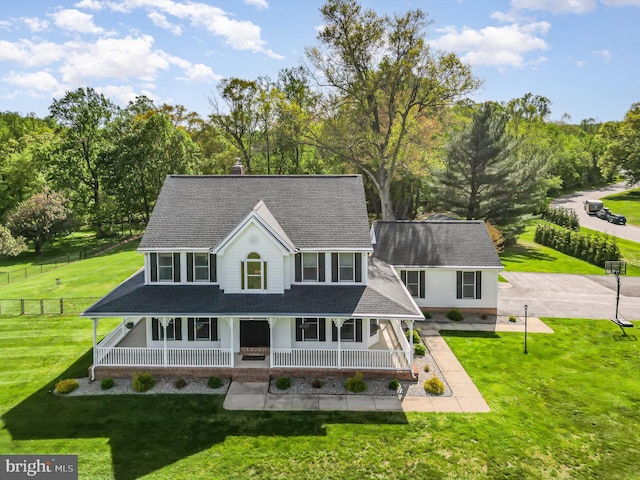 view of front of house featuring a porch, a front yard, fence, and roof with shingles