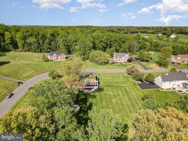 bird's eye view featuring a wooded view