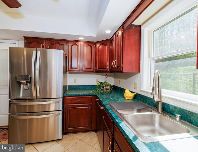 kitchen featuring appliances with stainless steel finishes, a sink, dark brown cabinets, light tile patterned flooring, and recessed lighting