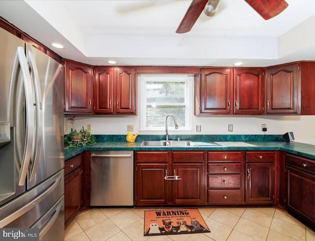 kitchen with stainless steel appliances, a sink, dark brown cabinets, dark countertops, and recessed lighting